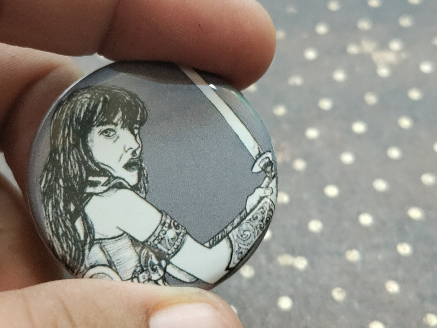 Embrace your inner warrior with our Xena Warrior Princess Pinback Button